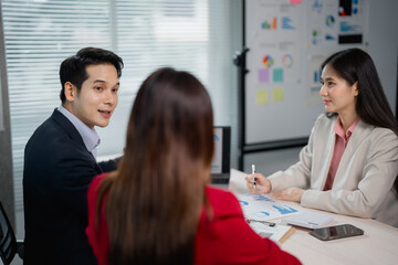 Business team discussing and brainstorming during meeting in office, focusing on analyzing and...