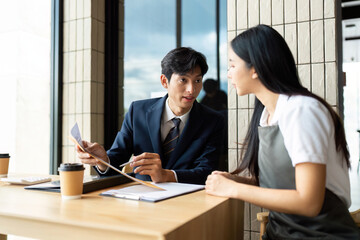 Strategic Business Meeting. Professionals discussing project details in a modern office space.