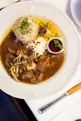 Delicious venison stew with bread dumpling, lingonberry sauce and horseradish, served in Styria, Austria