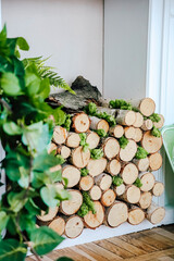 Unique wood stack with greenery adds charm to modern interior decor in bright setting