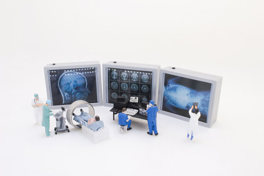 A Miniature Medical Team Analyzing Diagnostic Imaging - Powered by Adobe