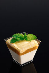 Panna cotta tropic vanilla panna cotta, mango, mango-passion fruit mousse. Glass with chocolate mousse panna cotta. Sweet delicious dessert decorated with whipped cream topping. Copy space
