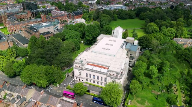 Side-on rotating aerial video of Ulster Museum in Botanic Gardens in Belfast, Northern Ireland on a bright sunny day. Produced in 4K, 30 frames per second and with Rec709 color.