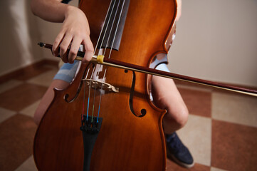 Close-Up of Student Playing a Cello in a Music Practice Setting