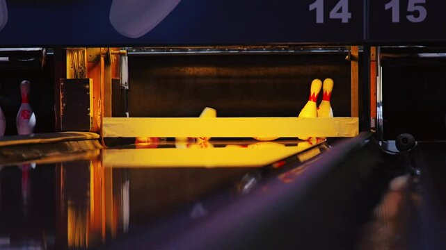 Colorful reflections and smooth slow motion show bowling strike in vibrant scene