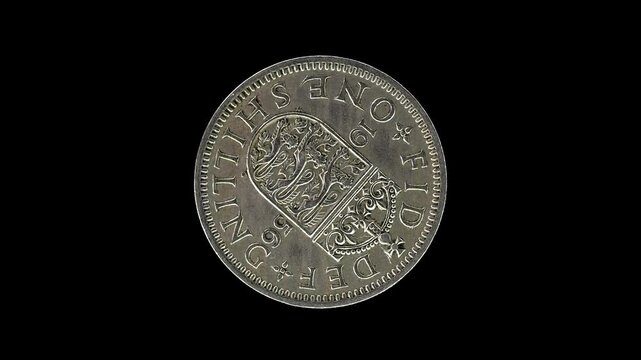United Kingdom 1956 one shilling coin reverse with crowned English shield of arm rotating on black background