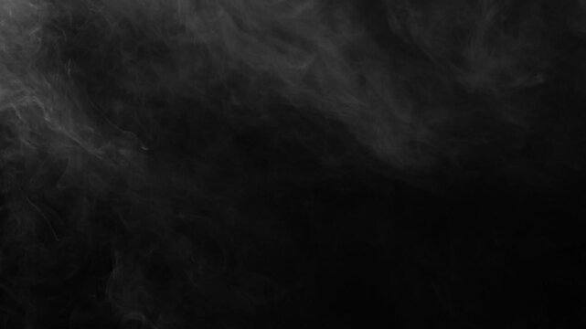 Dark, moody fog textures swirl gently in upper left of black screen. Perfect atmospheric background for horror, suspense, or cinematic titles