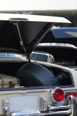 Fototapeta premium A classic car trunk with polished chrome and vintage design, show the automotive craftsmanship and retro elegance.