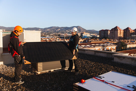 Rooftop solar panel installation process under sunlight