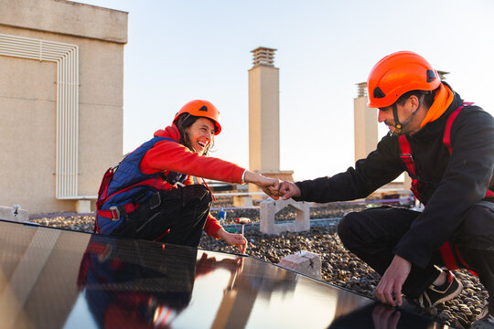 Rooftop solar installation with workers collaborating