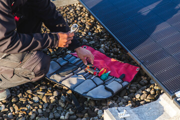 Rooftop solar panel installation with tools and technician