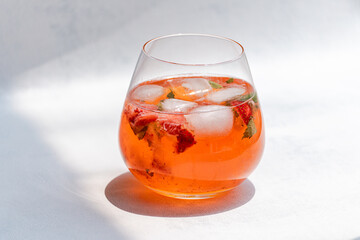 Refreshing summer fruit drink with ice and mint