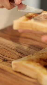 Spreading Vegemite on Toast in a Kitchen Setting