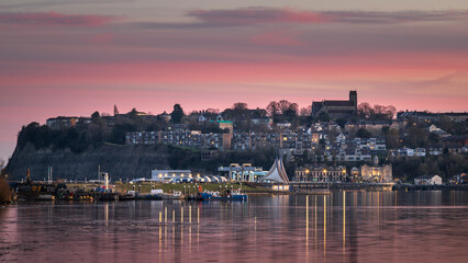 Cardiff Bay, looking towards Penarth, south Wales, during a beautiful, red sunset.  The lights are reflecting on the calm water