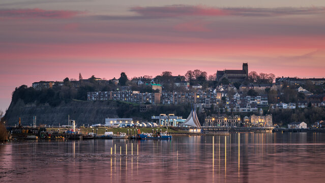 Cardiff Bay, looking towards Penarth, south Wales, during a beautiful, red sunset.  The lights are reflecting on the calm water