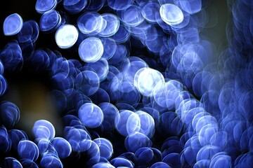 Abstract bokeh of vibrant, circular lights in shades of blue and dark backgrounds