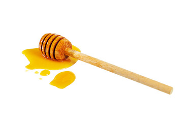 Honey puddle with wooden honey spoon isolated on white.