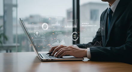 A man in a suit types on a laptop with digital data visualizations overlayed on the screen.