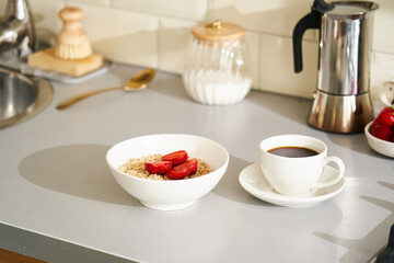 Breakfast with oatmeal, strawberries, and coffee