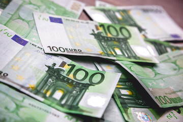 Close-up of multiple 100 euro banknotes, financial wealth concept