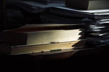 Stack of old books on a wooden table. Selective focus.