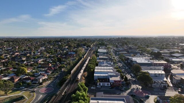 Drone Shot of Sydney Suburban Train at Sunset Flying Over Sefton to Lidcombe