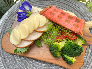 Soft tofu and slice chicken Beetroot waffle sandwiches with broccoli and cherry tomato.