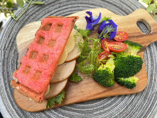 Soft tofu and slice chicken Beetroot waffle sandwiches with broccoli and cherry tomato.