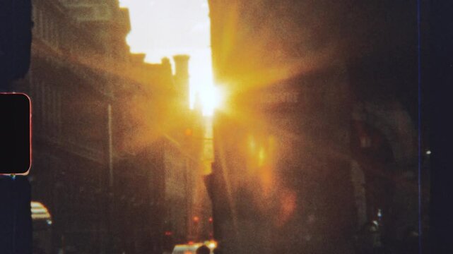 Super 8 film look: setting sun illuminating city street with vintage atmosphere