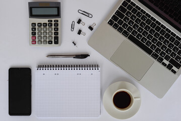 A modern office workspace equipped with essential tools, beverages, and coffee supplies