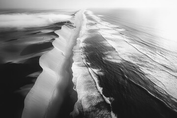 Aerial view of ocean waves breaking on a sandy beach with sand dune features.