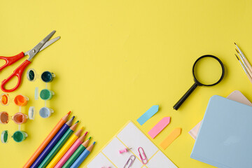 A Creative Workspace Filled with Colorful Art Supplies Set Against a Yellow Background