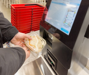 Self-checkouts or self-service checkouts,man paying for the purchases  in supermarkets