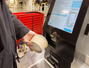 Self-checkouts or self-service checkouts,man paying for the purchases  in supermarkets