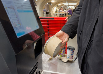 Self-checkouts or self-service checkouts,man paying for the purchases  in supermarkets
