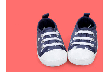 Adorable navy blue baby shoes with white stars and laces. Designed for comfort and cuteness, these soft-soled sneakers are perfect for baby boys.