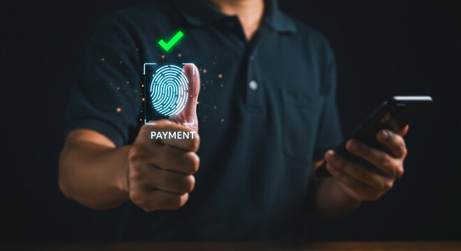 Seamless Transaction: Man securely approves a digital payment via fingerprint scanning, against a dark background.