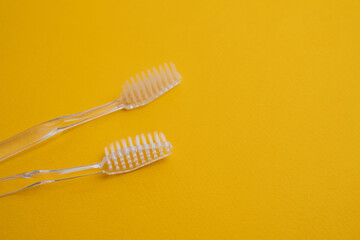 White toothbrushes on a color background. Replace your old toothbrush with a new one. Old and new...