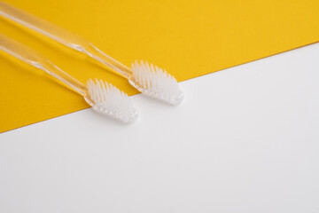 White toothbrushes on a color background. Replace your old toothbrush with a new one. Old and new...