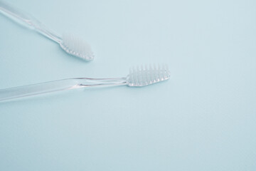 White toothbrushes on a color background. Replace your old toothbrush with a new one. Old and new toothbrushes. Dental health and hygiene concept 