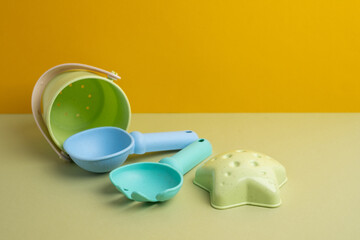Children's toys, a shovel, a rake and crispy colorful snacks. Summer mood on the beach