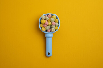 Children's toys, a shovel, a rake and crispy colorful snacks. Summer mood on the beach