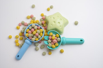 Children's toys, a shovel, a rake and crispy colorful snacks. Summer mood on the beach