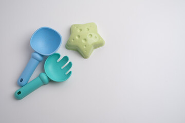 Children's toys, a shovel, a rake and crispy colorful snacks. Summer mood on the beach