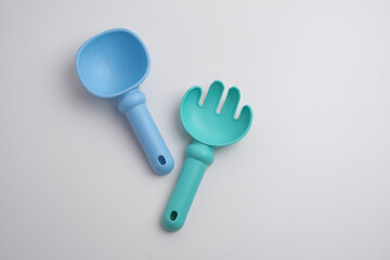 Children's toys, a shovel, a rake and crispy colorful snacks. Summer mood on the beach