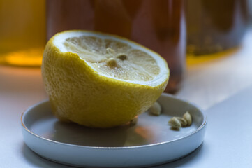 Lemon and honey in a glass jar on a white background.