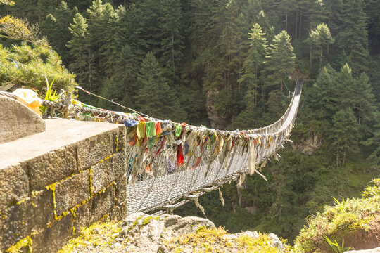 Suspension bridge with prayer flags in Everest region Nepal