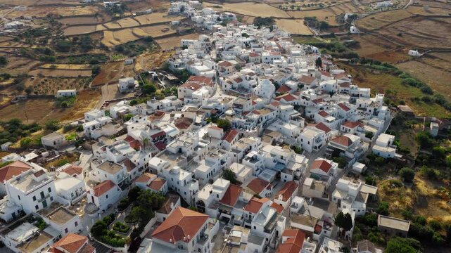 Drone circles around Kythnos Chora on Kythnos island during sunrise, Cyclades, Establishing shot