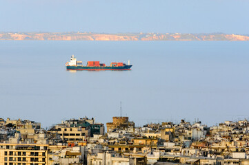 Container ship in the Thermaic Gulf passing near Thessaloniki, Greece, with the White Tower and...