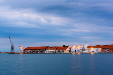 Industrial buildings and warehouses at the Port of Thessaloniki, Greece, during blue hour with...